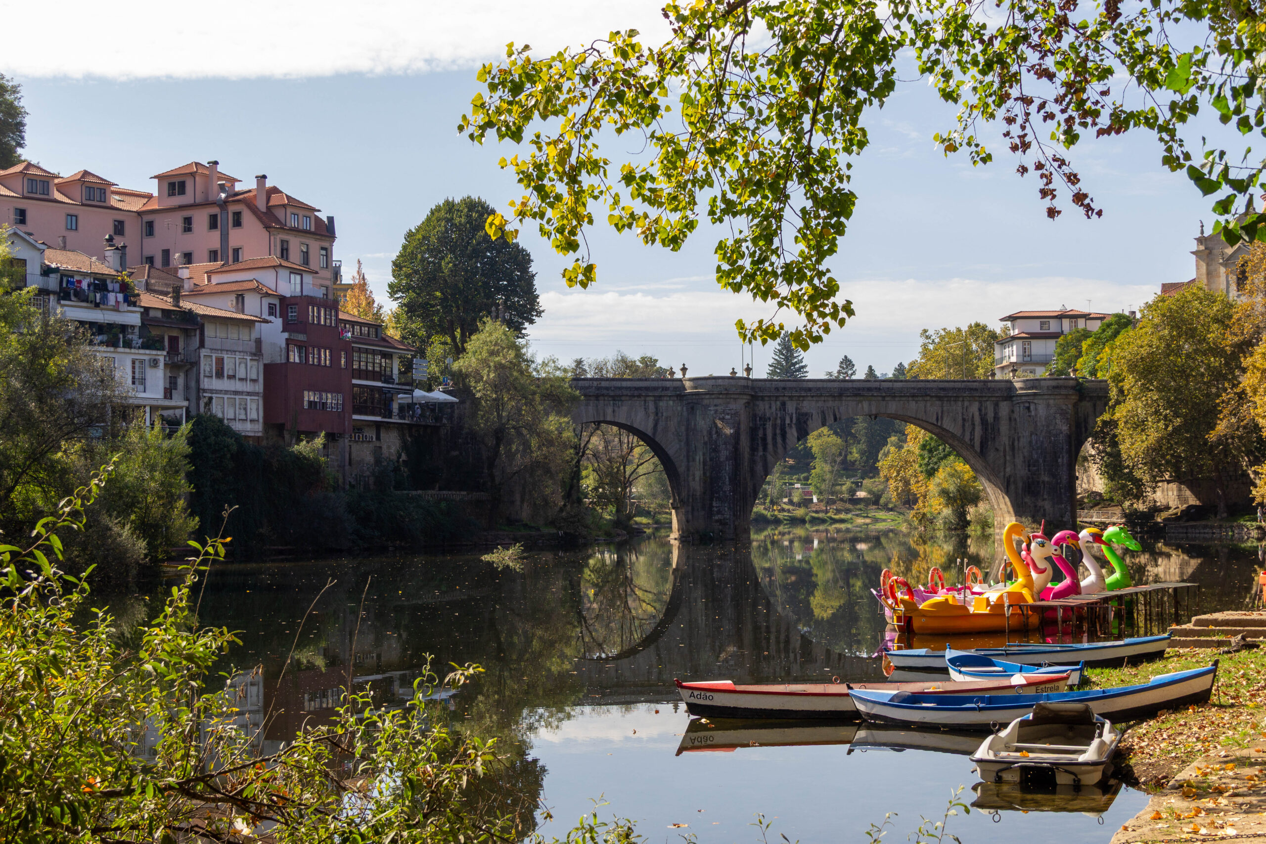 Scenic river view with colorful boats in Amarante