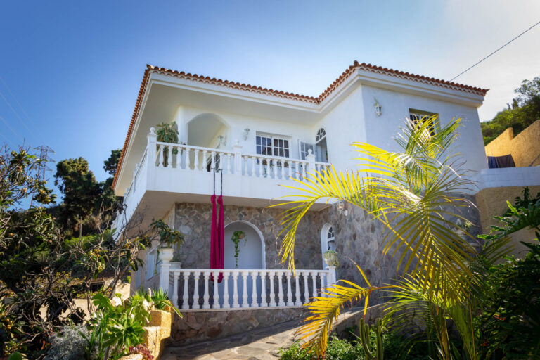 White house with tropical plants